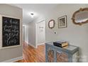 Well-lit hallway featuring wood floors and decorative wall art at 505 Melody Ln, Shelby, NC 28152