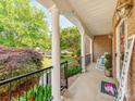 Inviting covered porch with stately columns, a cozy rocking chair, and a 'Welcome' sign adding a personal touch at 537 Montgrove Nw Pl, Concord, NC 28027