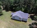Aerial view of a single-story home with a gray roof surrounded by a lush green lawn and mature trees at 5410 A R Gordon Rd, Waxhaw, NC 28173