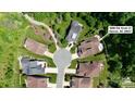 An aerial view of a home in a cul-de-sac featuring a well-maintained lawn and lush green trees at 5590 Elk Knob Ct, Denver, NC 28037