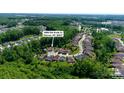 Aerial view showcasing a neighborhood surrounded by lush trees and manicured lawns at 5590 Elk Knob Ct, Denver, NC 28037