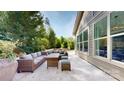 A stone patio area with comfortable seating, perfect for outdoor lounging and entertaining surrounded by greenery at 5590 Elk Knob Ct, Denver, NC 28037