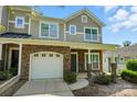 Charming two-story home with stone veneer, a garage, and a covered porch that creates curb appeal at 6333 Cory Bret Ln, Charlotte, NC 28278