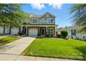 Attractive two-story home featuring stone accents, a well-maintained lawn, and an inviting front entrance at 6333 Cory Bret Ln, Charlotte, NC 28278