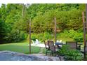 Beautiful backyard oasis featuring an outdoor living area with a hot tub and mature trees at 7170 Kenyon Dr, Denver, NC 28037