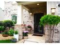 Inviting front porch with brick accents, potted plants, and a stylish front door at 7170 Kenyon Dr, Denver, NC 28037