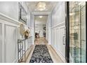 Elegant foyer with a crystal chandelier, decorative console table, and wood-look flooring at 7809 Creek Park Dr, Denver, NC 28037