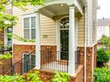 Charming townhome entrance featuring white columns, brick accents, and a dark front door at 815 Granby Dr, Fort Mill, SC 29708