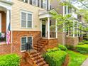 Inviting townhome entrance with brick stairs, black railings, and landscaped garden at 815 Granby Dr, Fort Mill, SC 29708