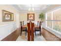 Formal dining room with a chandelier, wainscoting, and a large window at 8460 Fairgreen Ave, Waxhaw, NC 28173