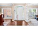 Bright foyer with hardwood floors, large windows, and a white front door at 8460 Fairgreen Ave, Waxhaw, NC 28173