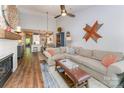 Spacious living room featuring hardwood floors, a fireplace, and an open floor plan to the kitchen at 915 Northeast Dr # 15, Davidson, NC 28036