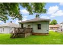 Green backyard view of home with wooden deck and ample space for outdoor activities at 92 E Spencer Mountain Ave, Gastonia, NC 28054