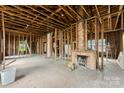 Spacious living room with exposed brick fireplace and an open layout ready for renovation at 92 E Spencer Mountain Ave, Gastonia, NC 28054