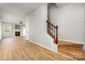 Open living room with wood floors, fireplace, and staircase at 9630 Turning Wheel Dr, Charlotte, NC 28214