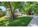 Well-manicured lawn and mature shade trees create a pleasant outdoor setting in this home's front yard at 11802 Fox Glen Rd, Charlotte, NC 28269