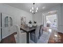 Elegant dining room featuring a chandelier, modern table setting, and bright natural light at 1201 Beckford Glen Dr, Waxhaw, NC 28173