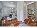 Inviting hallway with hardwood floors leading to a dining room and living room at 1201 Beckford Glen Dr, Waxhaw, NC 28173