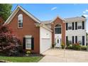 Charming two-story brick home with manicured landscaping and an attached two-car garage at 13528 Philip Michael Rd, Huntersville, NC 28078