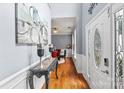 Welcoming foyer featuring hardwood floors, elegant wainscoting, and a decorative front door at 13528 Philip Michael Rd, Huntersville, NC 28078