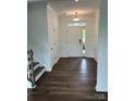 Bright entryway featuring hardwood floors, white trim, and a glass-paned front door at 15208 Caspian Way, Charlotte, NC 28278