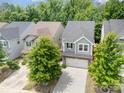 An aerial view showcases a two-story home nestled among mature trees in a well-developed residential neighborhood at 15524 Scholastic Dr, Charlotte, NC 28277