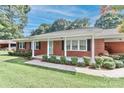 Classic brick home with a covered porch, offering curb appeal and a cozy entrance at 158 Jane Sowers Rd, Statesville, NC 28625