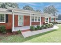 Inviting brick home with a covered porch, neat landscaping, and a welcoming entryway at 158 Jane Sowers Rd, Statesville, NC 28625