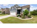 Beautiful home with blue siding, stone accents, landscaped lawn, and two car garage at 1663 Tranquility Blvd, Lancaster, SC 29720
