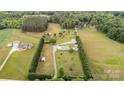 Aerial view of a vast property with a well-maintained lawn, trees and a home with multiple outbuildings at 1720 Lowe Dr, Catawba, NC 28609
