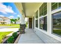 Inviting covered front porch with stone columns and manicured landscaping enhances the entrance at 173 Morgans Branch Rd, Belmont, NC 28012