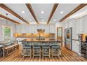 Beautiful kitchen with a stone island, barstool seating, stainless steel appliances, and wood beam ceiling at 1849 Still Water Ln, Indian Land, SC 29707