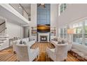 Spacious living room with a fireplace, soaring ceilings, large windows, and neutral decor at 1849 Still Water Ln, Indian Land, SC 29707