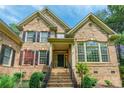 Inviting brick home with a covered entrance and meticulously landscaped front yard at 1868 Chestnut Hill Dr, Tega Cay, SC 29708