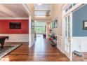 Elegant foyer with hardwood floors, open staircase, and views into multiple living areas at 1868 Chestnut Hill Dr, Tega Cay, SC 29708