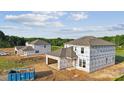Unfinished homes under construction, showcasing the initial stages of development in a residential area at 21047 Running Creek Dr # 9, Locust, NC 28097