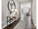 Stylish entryway features a modern console table, round mirror, and a view into the living area at 21055 Running Creek Dr # 10, Locust, NC 28097