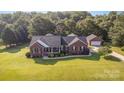 Sprawling aerial view showcasing the home, manicured grounds, and a detached garage at 214 Silver Creek Ln, Shelby, NC 28152