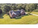 Expansive aerial view of a brick home with lush green lawn and tree lined perimeter at 214 Silver Creek Ln, Shelby, NC 28152