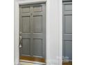 Close-up of a gray apartment door with a lock and white trim at 2315 Selwyn Ave # F, Charlotte, NC 28207