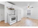 Bright kitchen featuring modern white appliances, ample cabinets and light wood floors at 2328 Danforth Ln, Charlotte, NC 28208