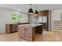Modern kitchen featuring a large island, stainless steel appliances, and stylish pendant lighting at 245 Enwood Dr, Charlotte, NC 28214