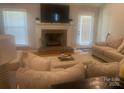 Cozy living room featuring a brick fireplace, plush seating, and ample natural light, perfect for relaxation at 2592 Tully Ct # 78, Lancaster, SC 29720