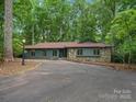 Charming single-story home with a stone facade, long driveway, and lush landscaping at 2730 Highway 557 Hwy, Clover, SC 29710