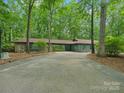 Charming single-story home with a stone facade, long driveway, and lush landscaping at 2730 Highway 557 Hwy, Clover, SC 29710