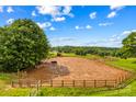 Large horse arena with lush greenery in the background; ideal for equestrian activities and training at 296 Hicks Creek Rd, Troutman, NC 28166