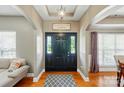 Elegant foyer with hardwood floors, arched doorways, and a stylish front door with sidelights at 3005 Streamlet Way, Monroe, NC 28110