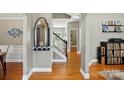 Inviting hallway showcasing hardwood floors, neutral paint, and decorative accents at 3005 Streamlet Way, Monroe, NC 28110