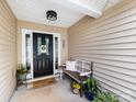 Welcoming front porch with a decorative door and cozy bench at 3347 Xandra Ct, Indian Land, SC 29707