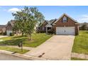 Traditional brick home with a well-kept lawn and a spacious driveway leading to an attached garage at 3419 Brickyard Ln, Midland, NC 28107